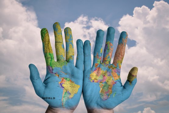 Hands with world map