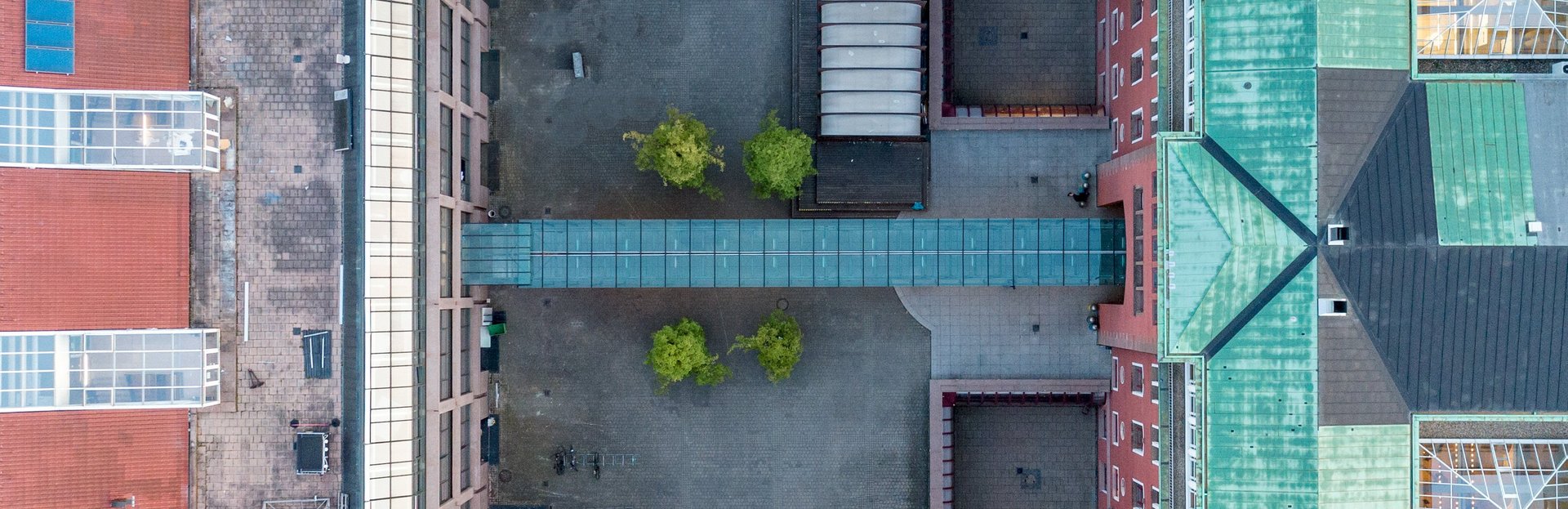 Aerial view showing the rooftops of Buildings 1 and 3 of HFT Stuttgart, which enclose an inner courtyard.